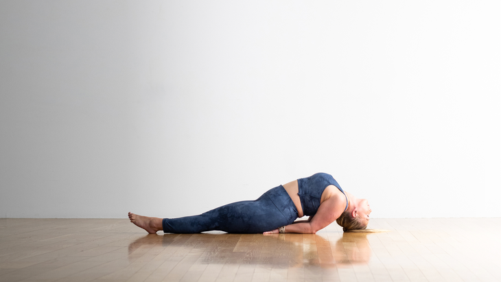 Woman practices Fish Pose