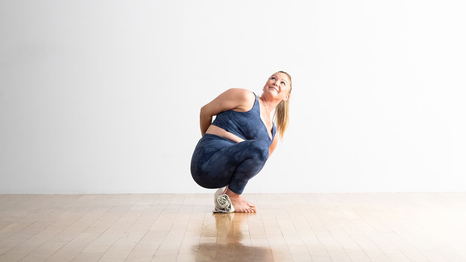 Woman demonstrates a modification of Rope Pose