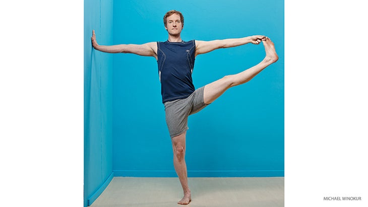 mc_266_01_FNL-credit-2 jason crandell, extended hand to big toe pose with wall assist, utthita hasta padangusthasana