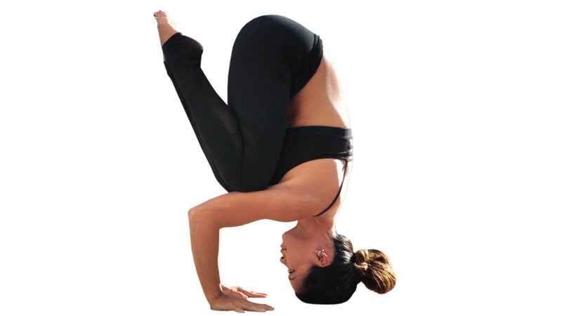 Beautiful woman practices inversion yoga asana Halasana - Plow pose in the  yoga studio Stock Photo - Alamy
