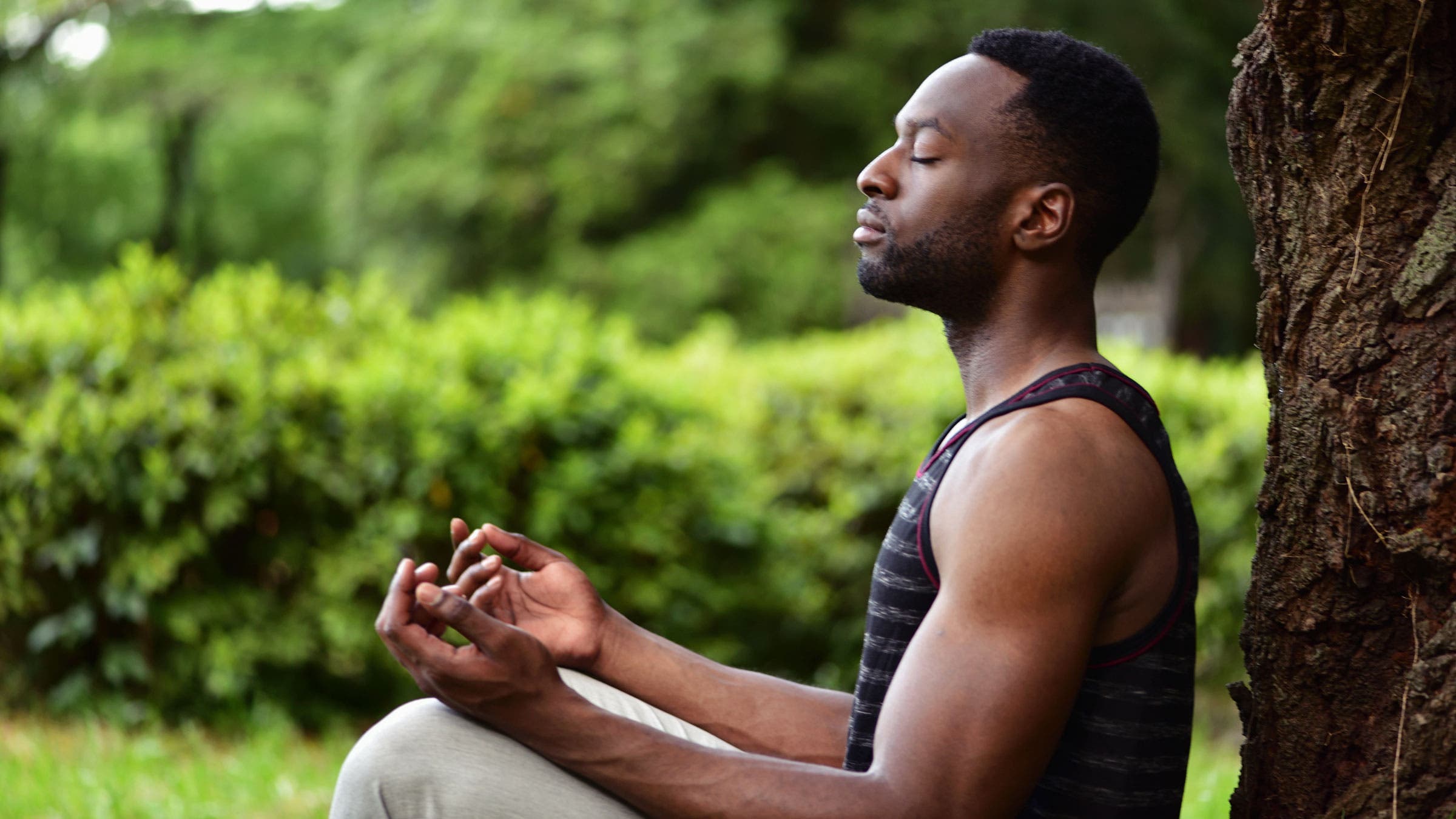 Man meditates outside