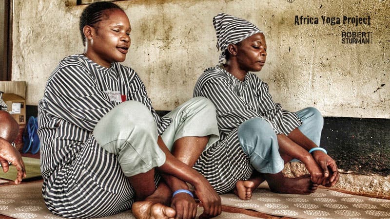 two women sitting cross-legged