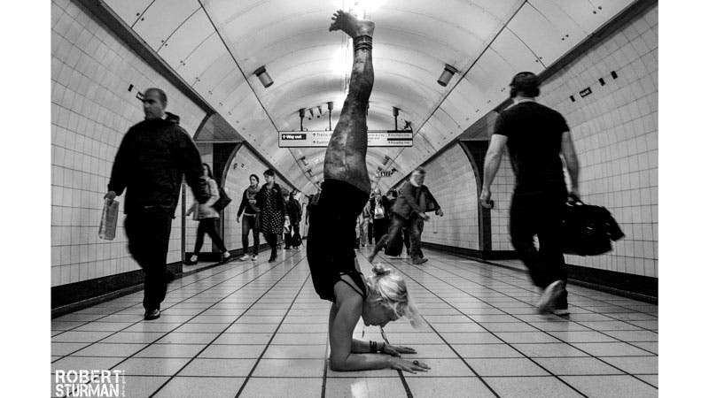 Sarah-Thompson--Victoria-Line,-London-Underground-(King's-Cross,-St-Pancras-Station) sarah thompson, forearm stand pose, pincha mayurasana
