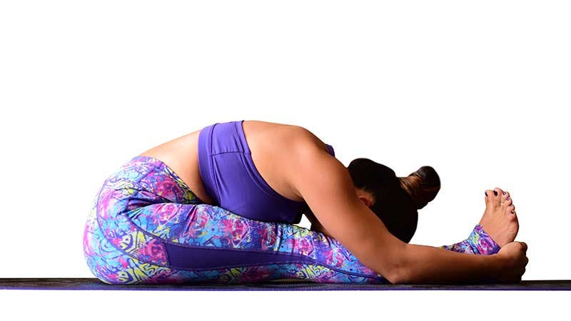 Two Fit Moms perform Seated Forward Bend. Two Fit Moms perform Seated Forward Bend.