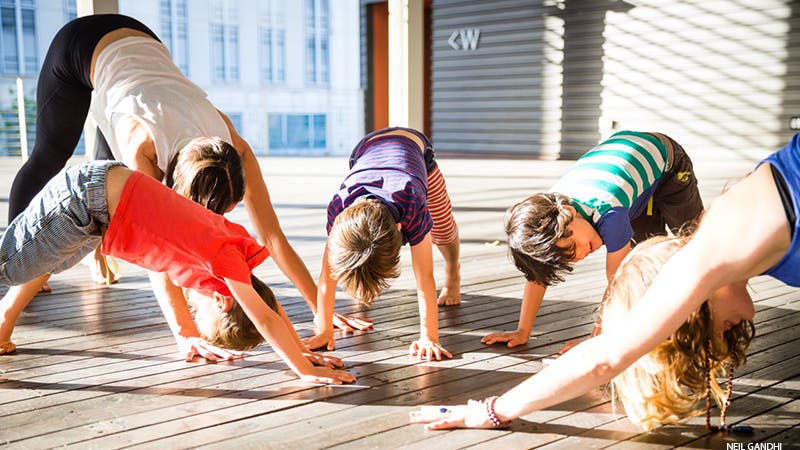 Leah Cullis and friends demonstrate Downward-Facing Dog.