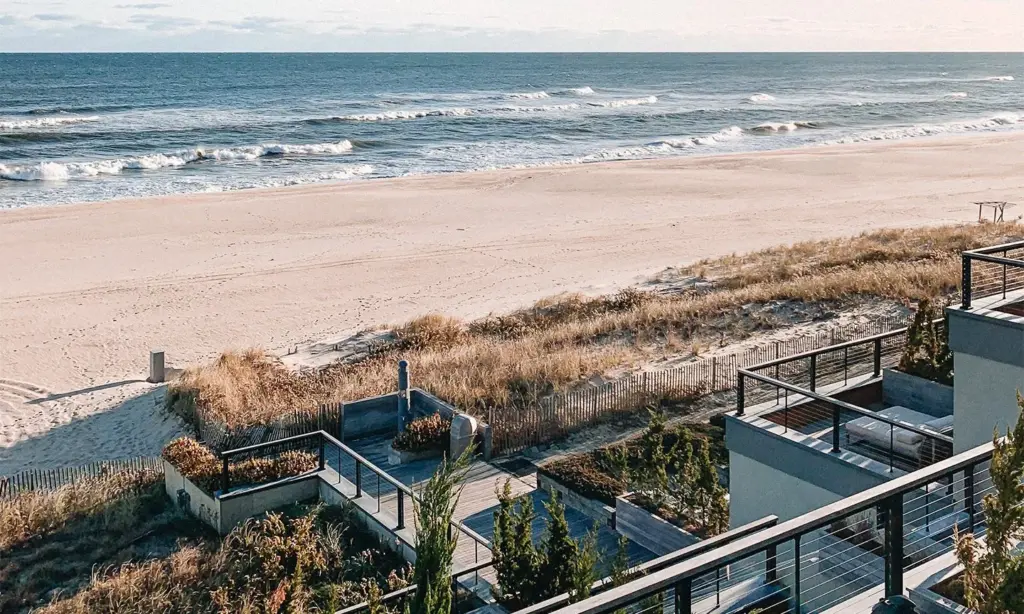 View of wooden stairs leading down to a private beach.