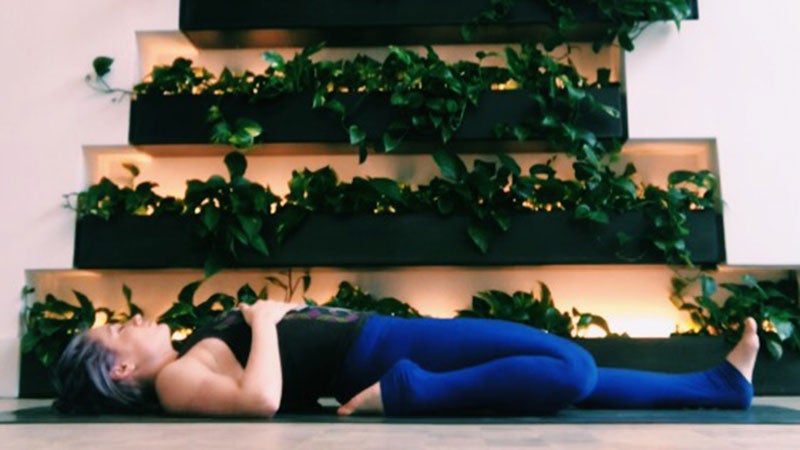 Young man practicing yoga in half hero stretch pose on, Stock Footage