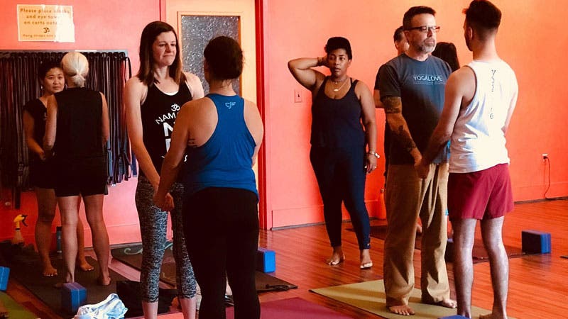 Yogis practice partnered eye-gazing to facilitate openness at Amplify and Activate.