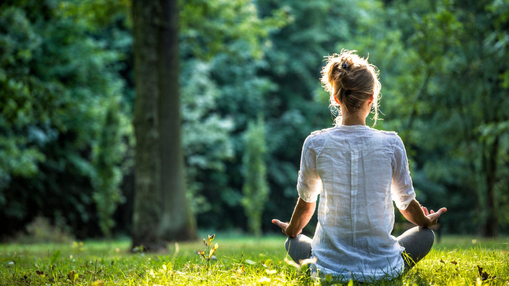 Woman in a calm, peaceful pose representing safety and healing