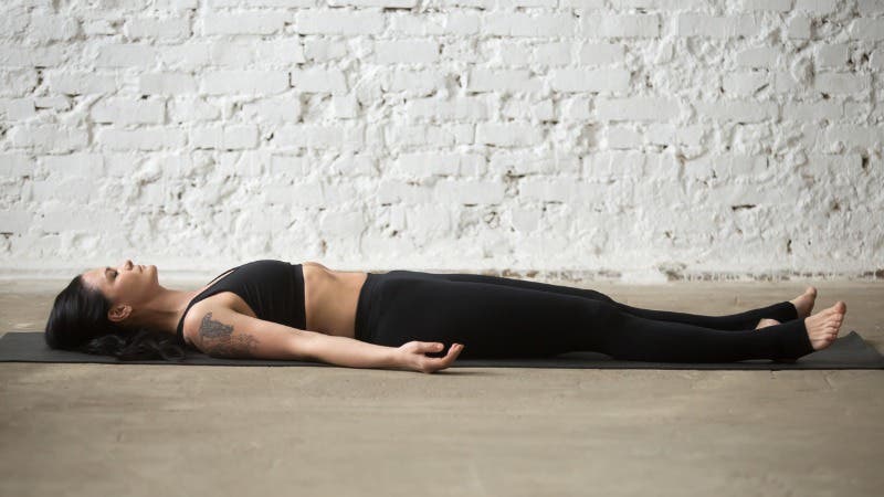 young-yogi-attractive-woman-in-savasana-pose-white-loft-background-picture-id667293934 None