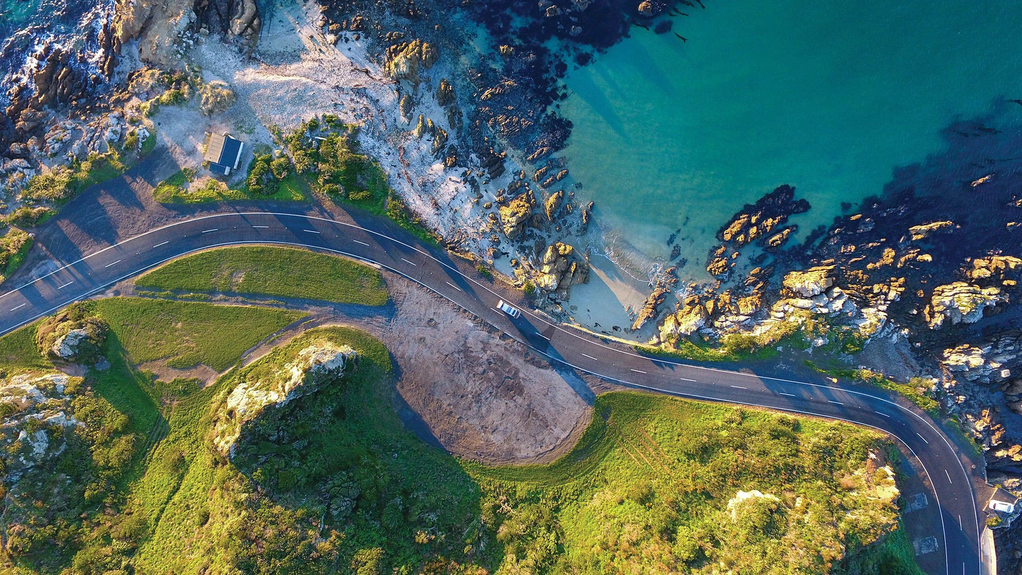 Top-down view of a road along a coastline