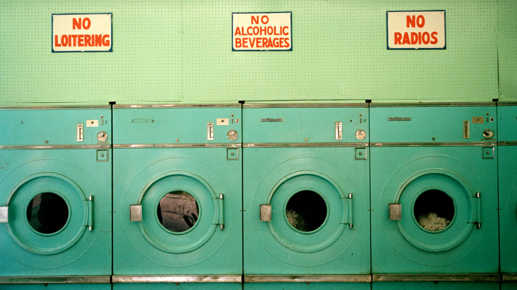 A laundromat with washing machines and detergent for washing a yoga mat