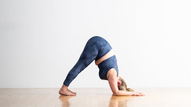 Woman demonstrates Dolphin Pose