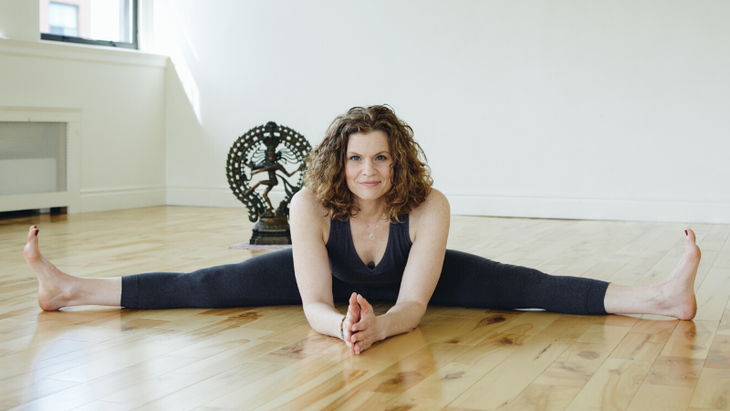 Yoga teacher conducting virtual yoga class at home on a video