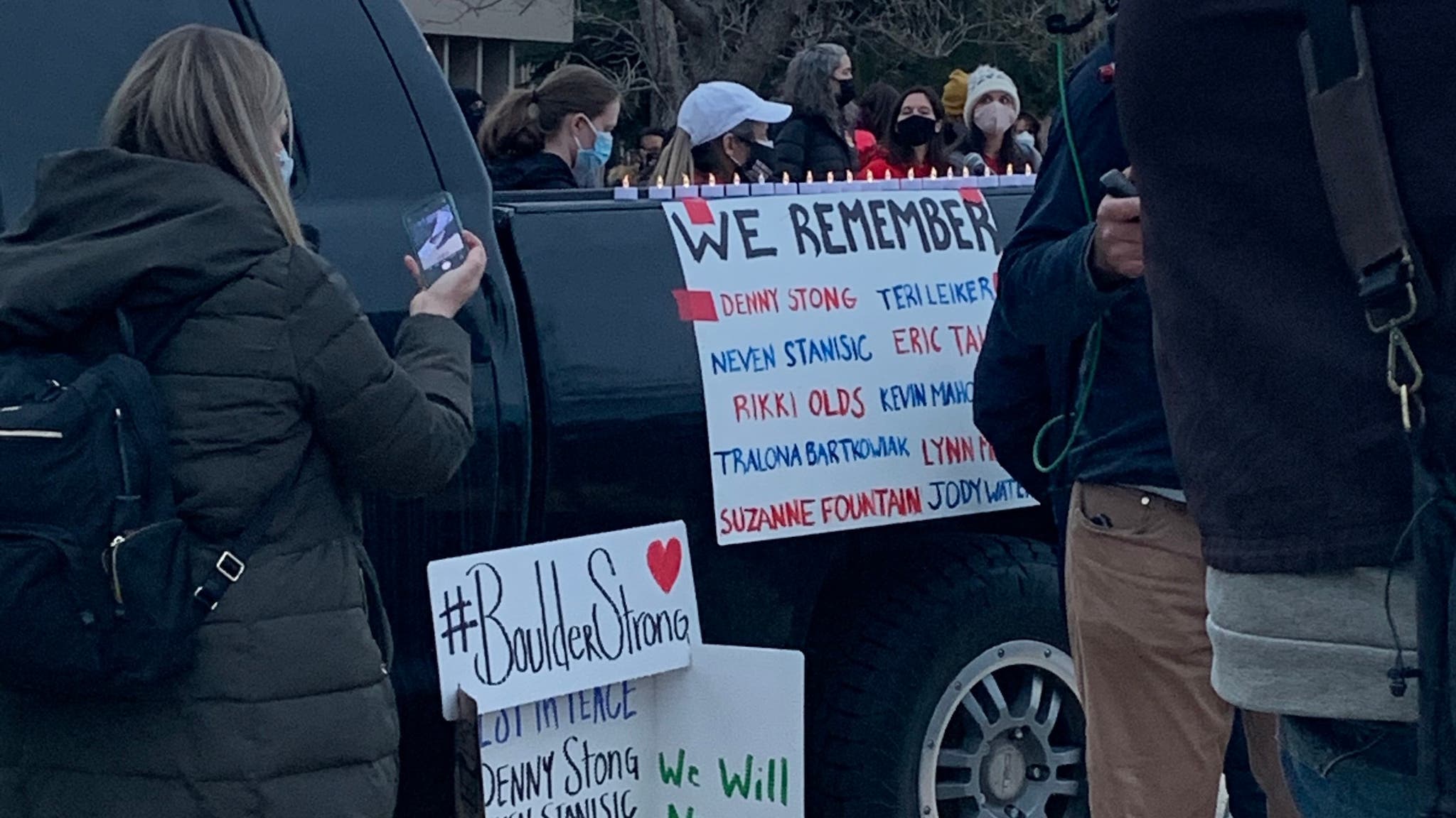 A sign on a black truck lists the names of 10 victims of the mass shooting in Boulder, Colorado