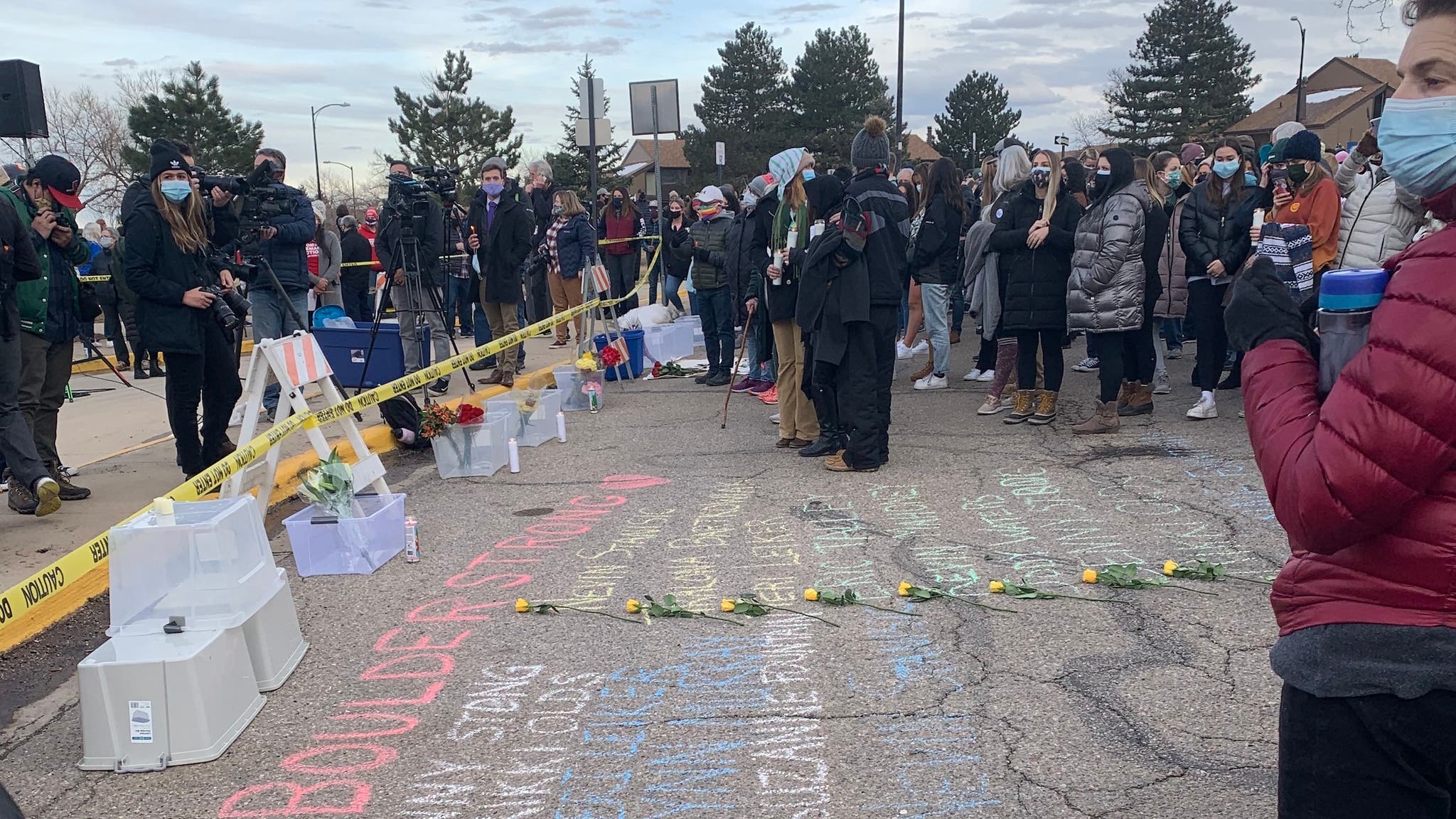 People gather at a memorial outside the King Soopers in Boulder, Colorado