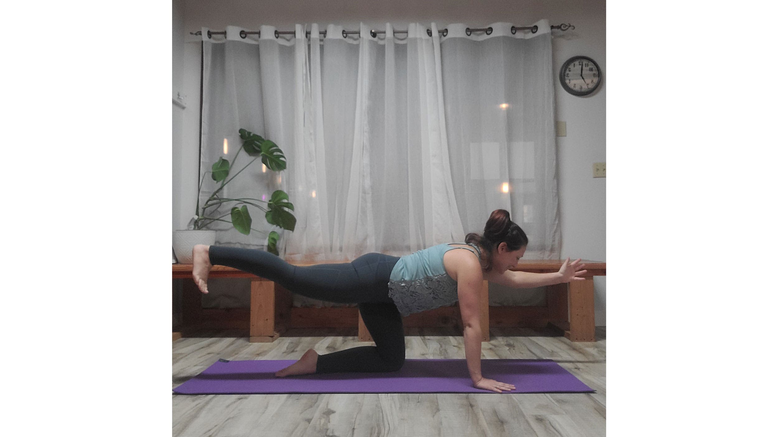 A person performs a variation of Tabletop pose in yoga