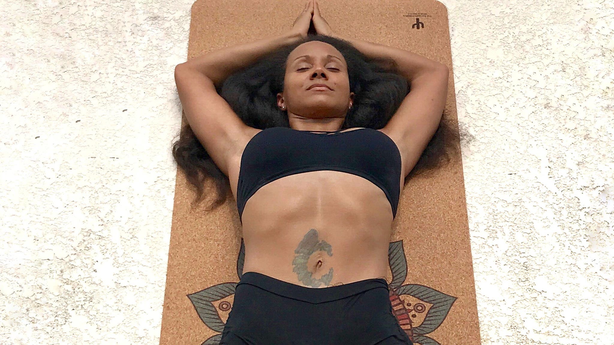 Woman lying on Samadh Initiative mat