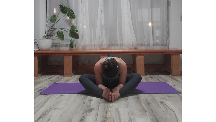 A person performs Baddha Konasana (Bound Angle Pose)Â