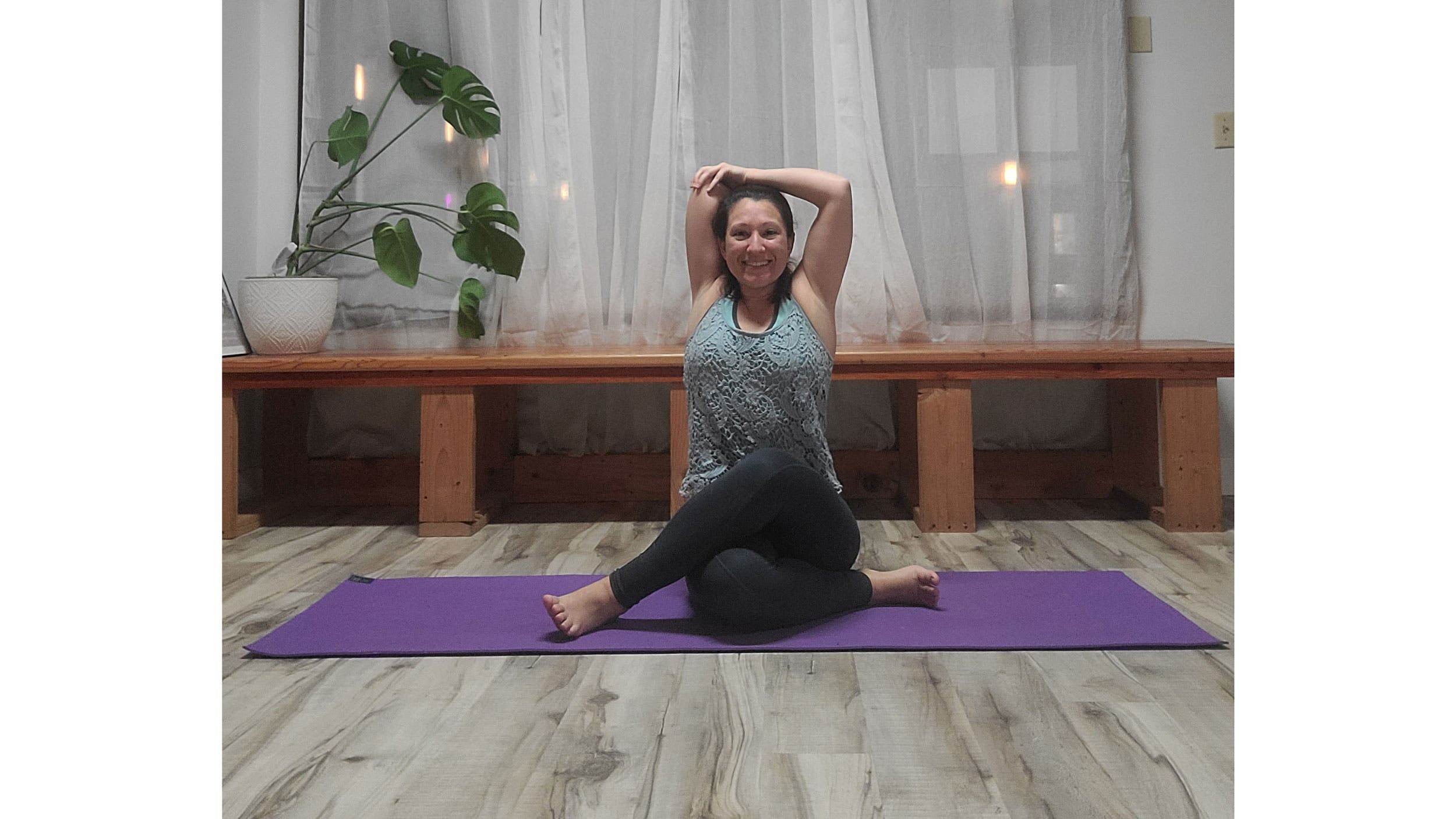 A person performs Gomukhasana, variation (Cow Face Pose)