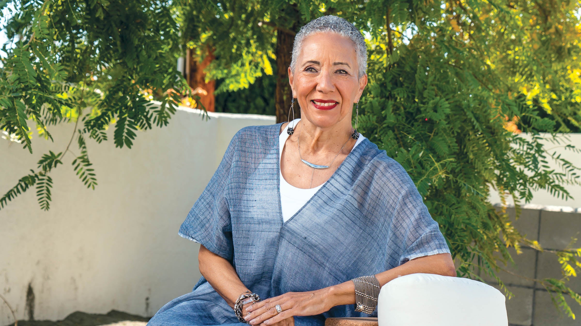 Gail Parker sitting and smiling outside