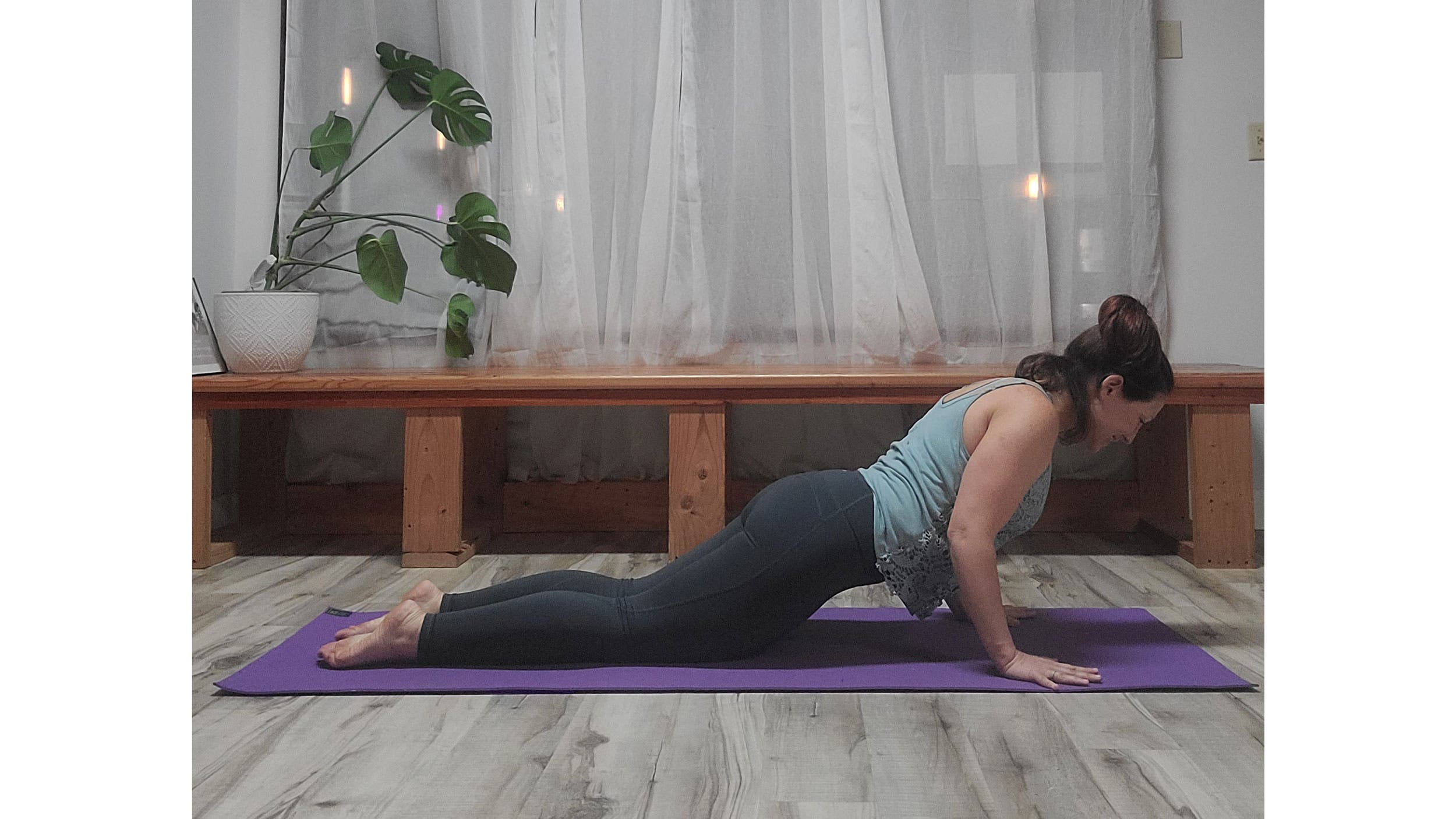 A person performs Chaturanga Dandasana, variation (Four-Limbed Staff Pose) 