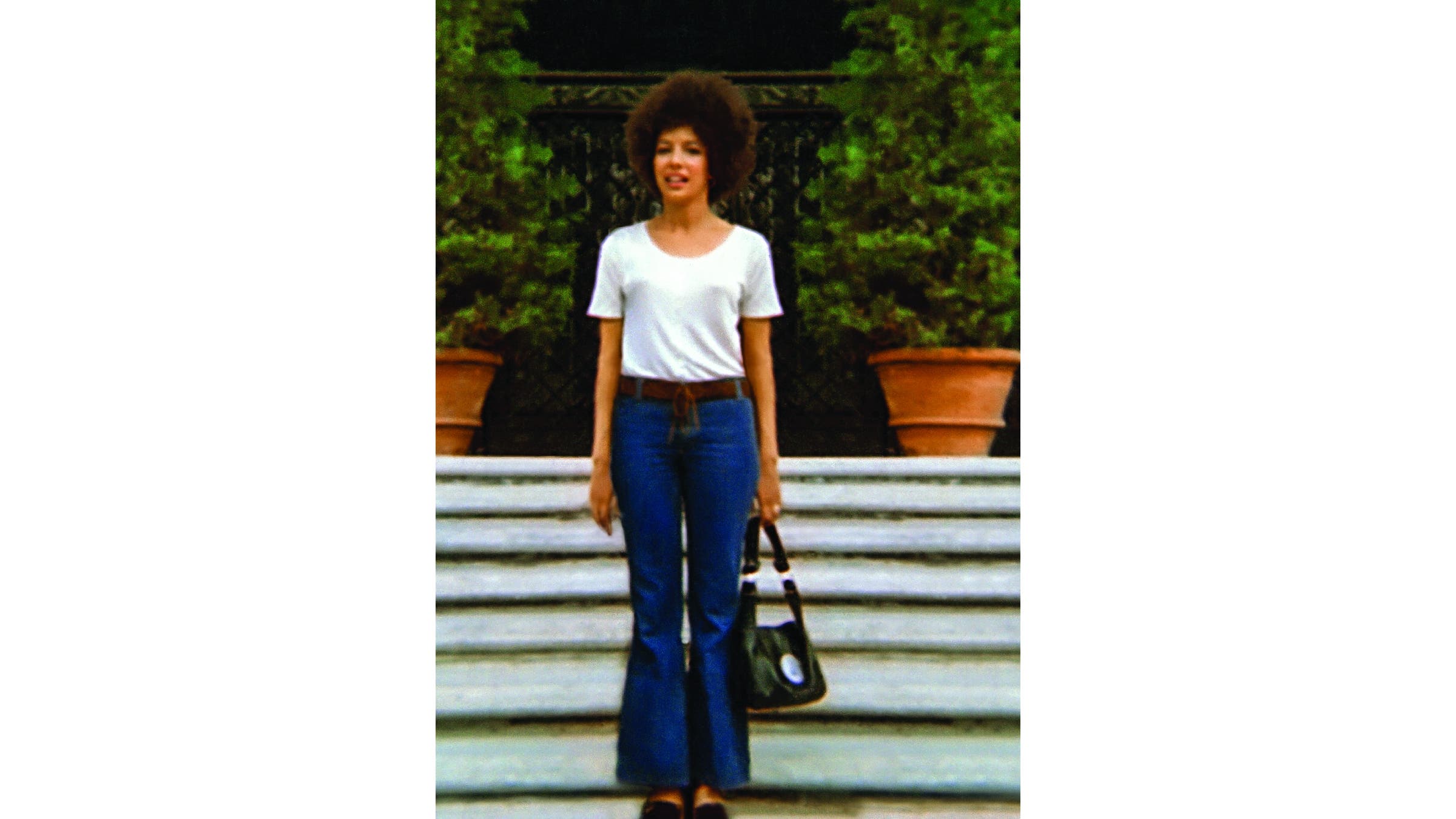 A young Gail Parker standing on a staircase