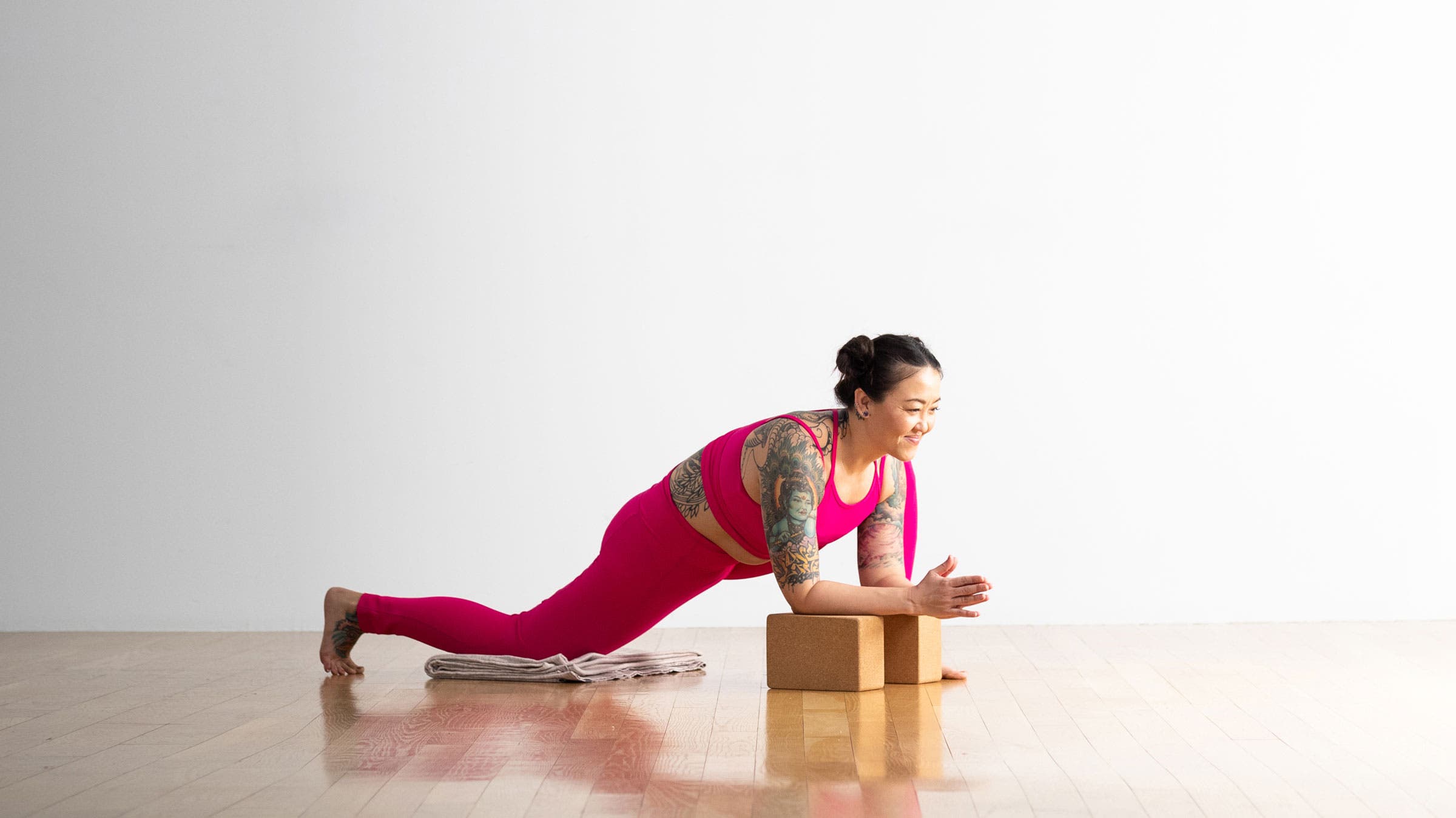 A woman does hip flexor stretches using yoga poses