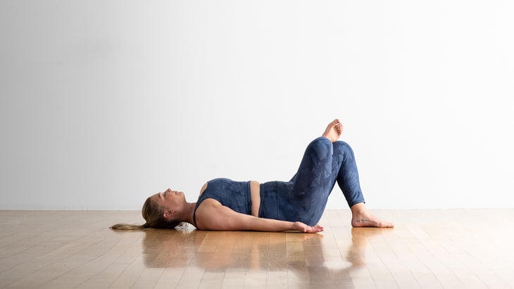 Woman demonstrating a pigeon pose variation