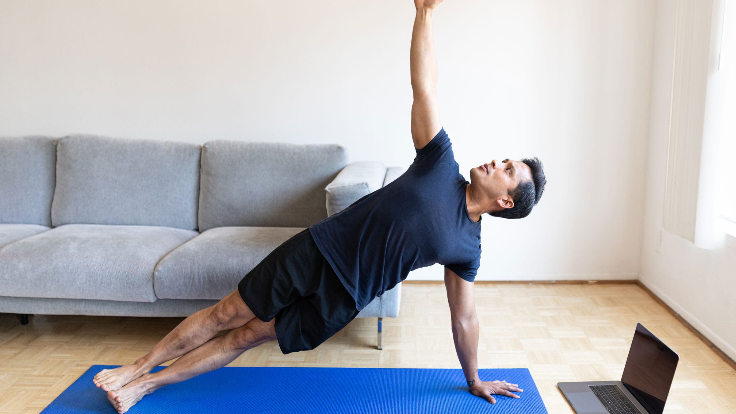 Man practice side plank at home