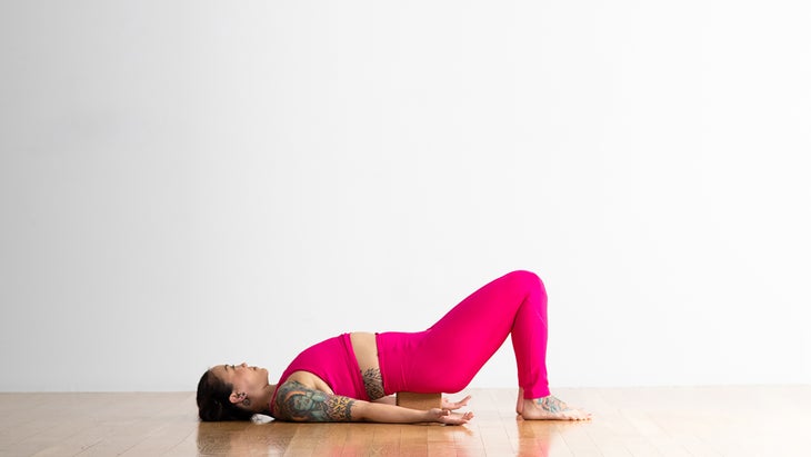 Woman in supported Bridge pose