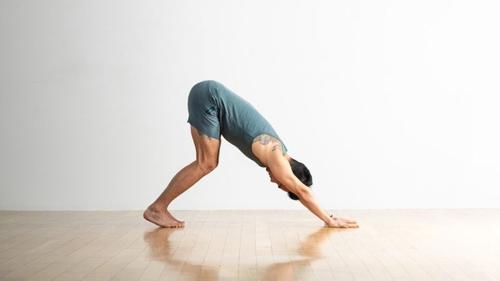 Man practicing Downward-Facing Dog Pose, one of the most basic yoga poses