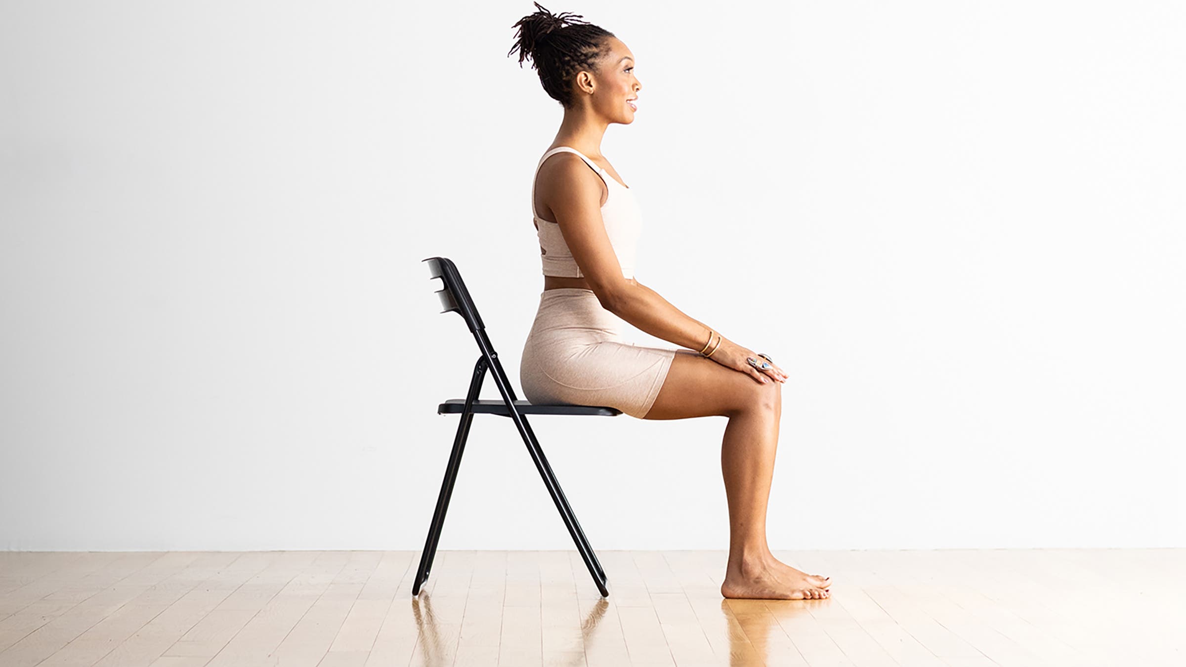 Woman demonstrating Easy Pose in a chair
