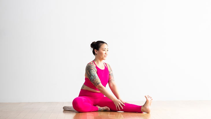 Woman in supported Head-to-Knee forward bend