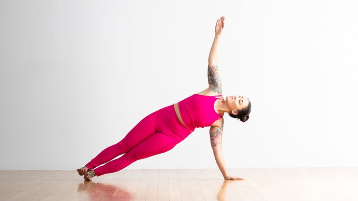 A person demonstrates Side Plank in yoga