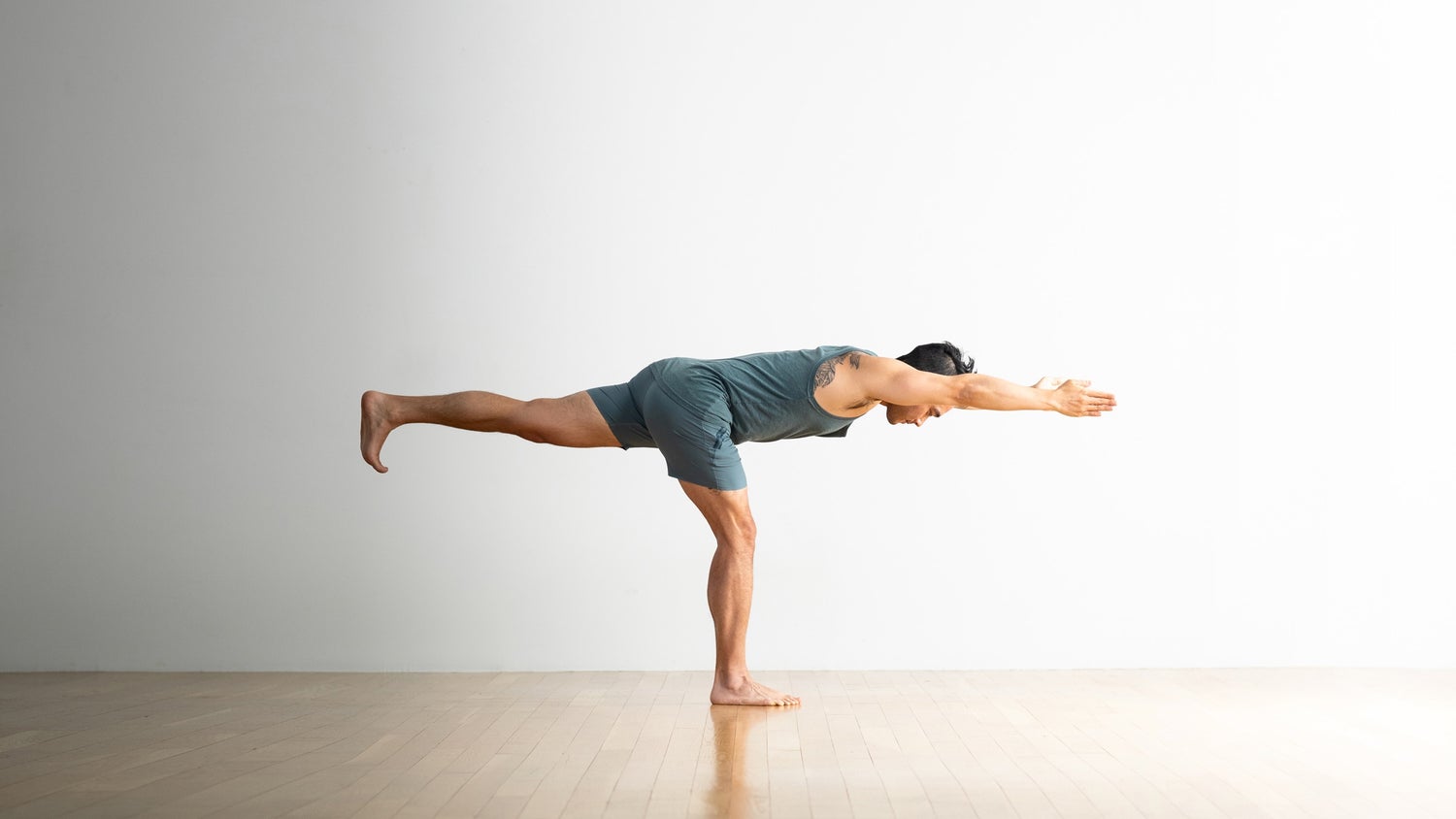 a man doing warrior 3 pose, yoga pose, warrior III