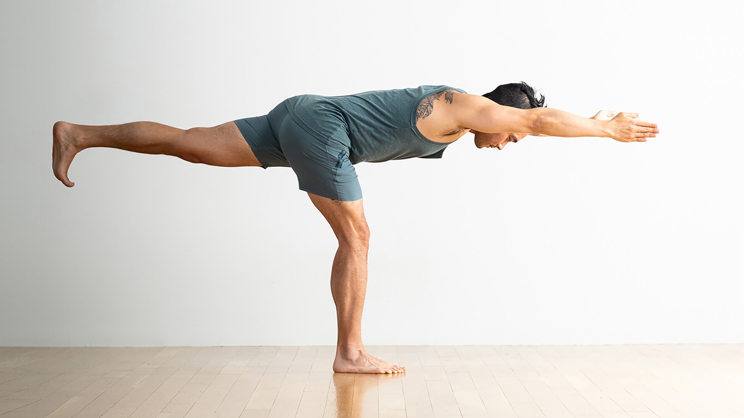 Person in Warrior III Pose, a yoga pose for leg strength