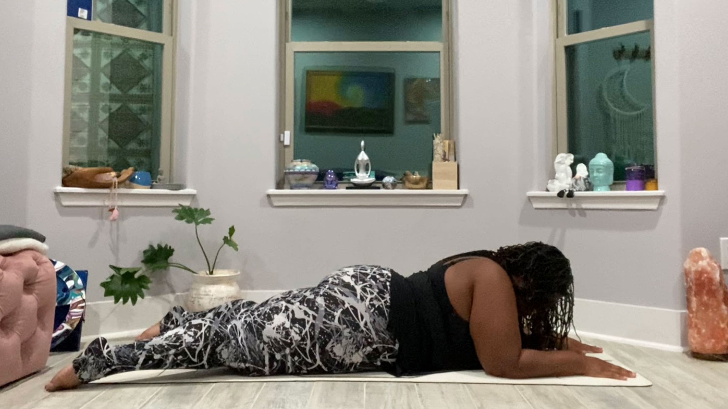 A woman demonstrates Sphinx Pose in Yin Yoga
