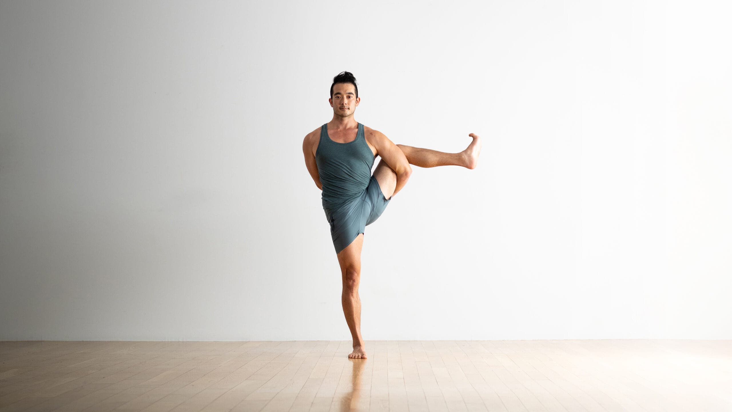 Hiro Landazuri practices Bird of Paradise with his lifted leg bent.