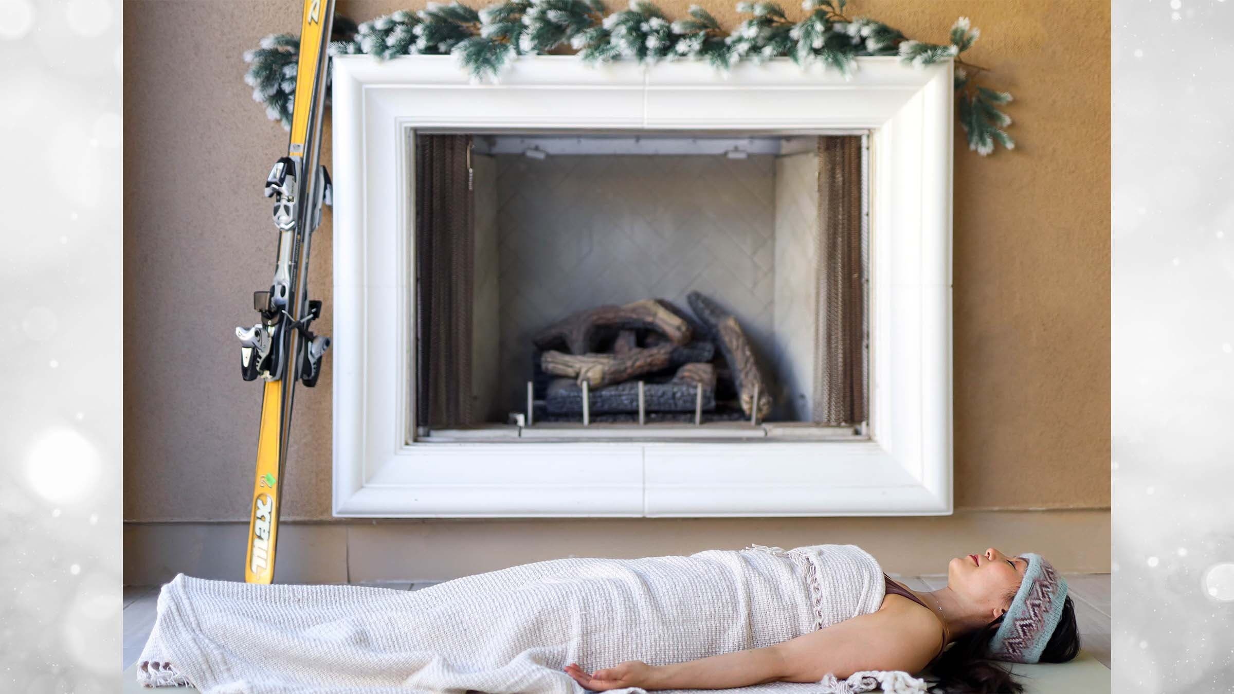 Ingrid Yang savasana in front of fireplace