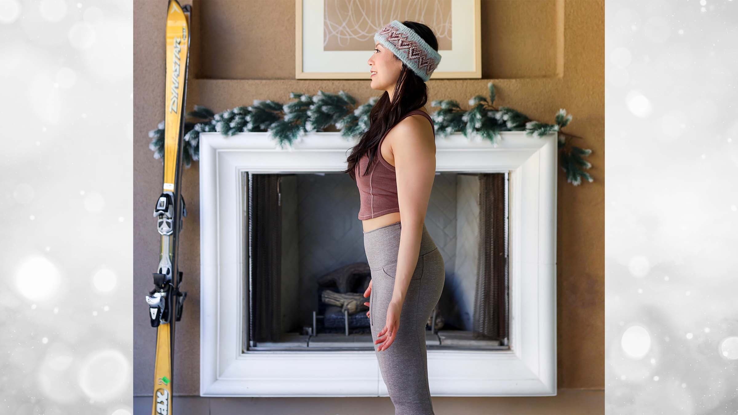 Ingrid Yang in Mountain Pose in front of a fireplace