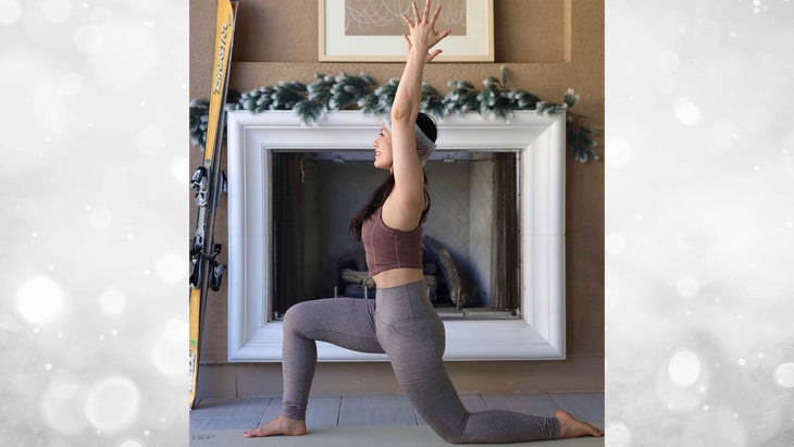 Beautiful yoga woman in santa hat practice yoga poses on grey