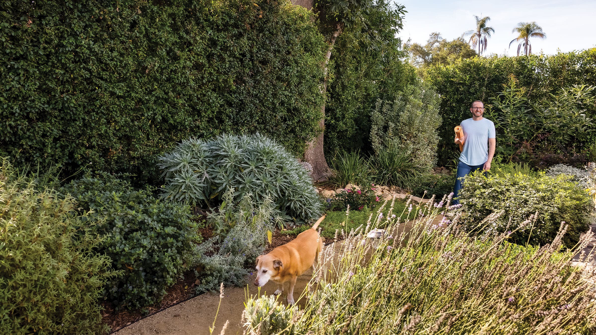 Heyman and his dog in his backyard