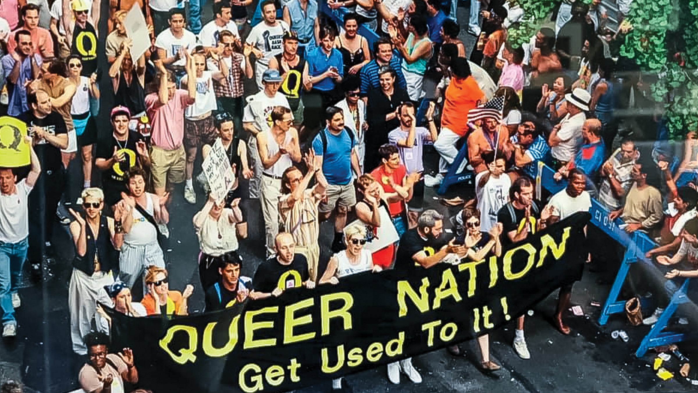 Group of people marching behind a Queer Nation banner