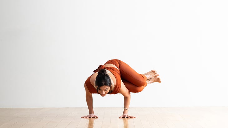 Woman performing a Side Crane Pose