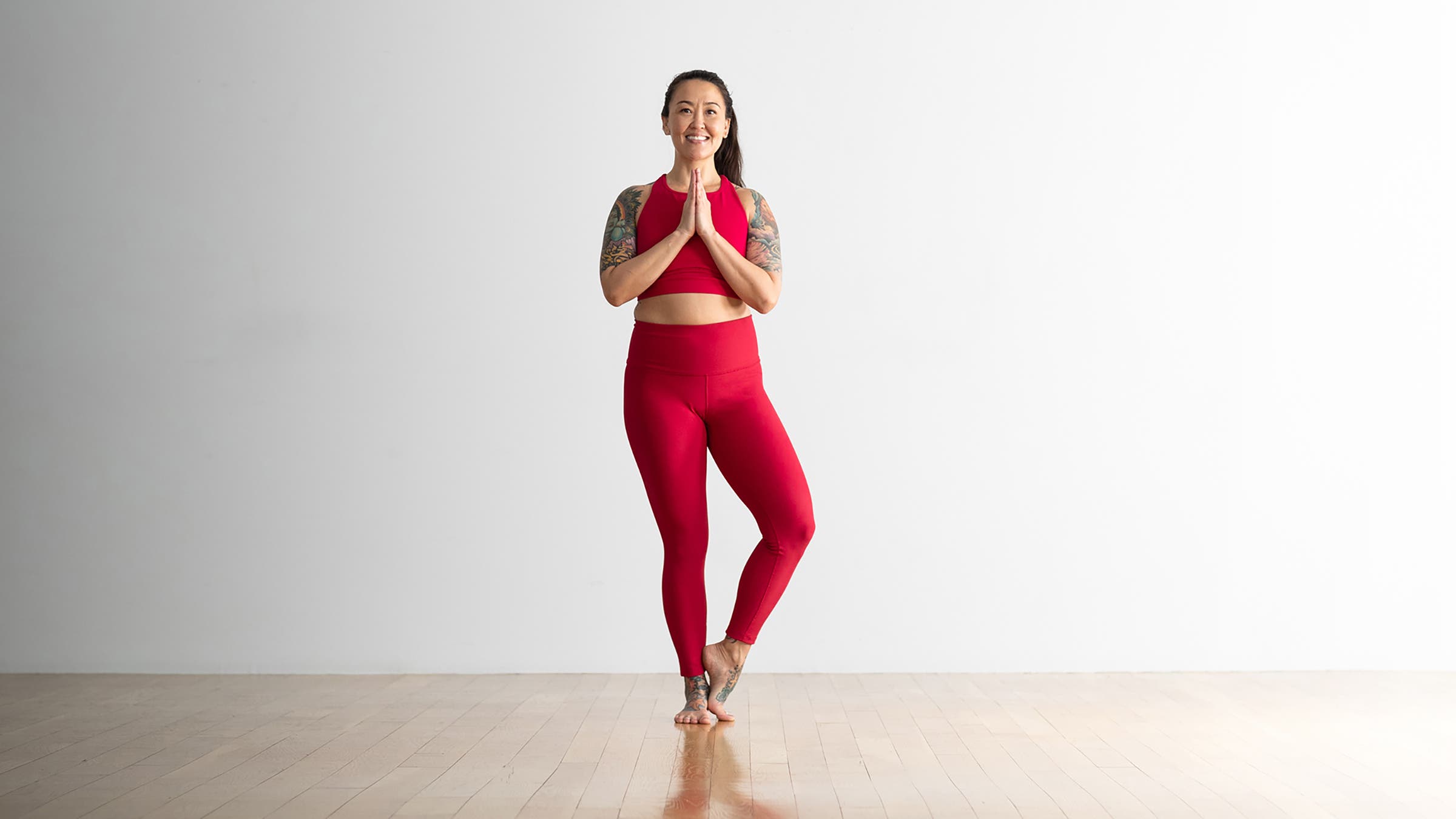 Woman in Tree Pose variation with foot lower