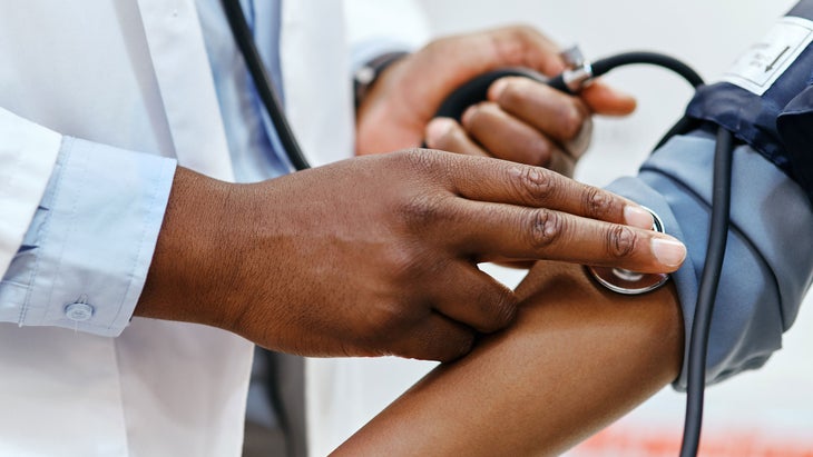 A doctor checks a person's blood pressure