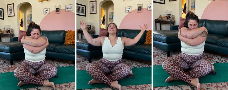 A person practices a heart opening embrace in yoga