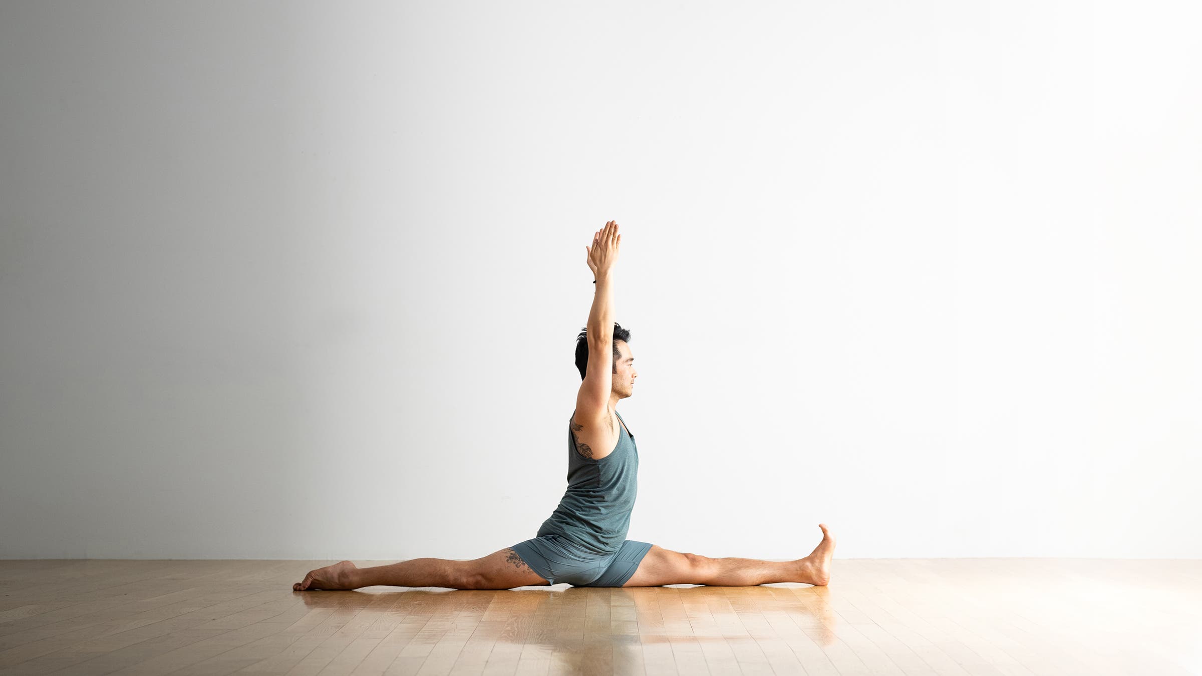 A person practices Hanumanasana, the Splits or Monkey Pose in yoga