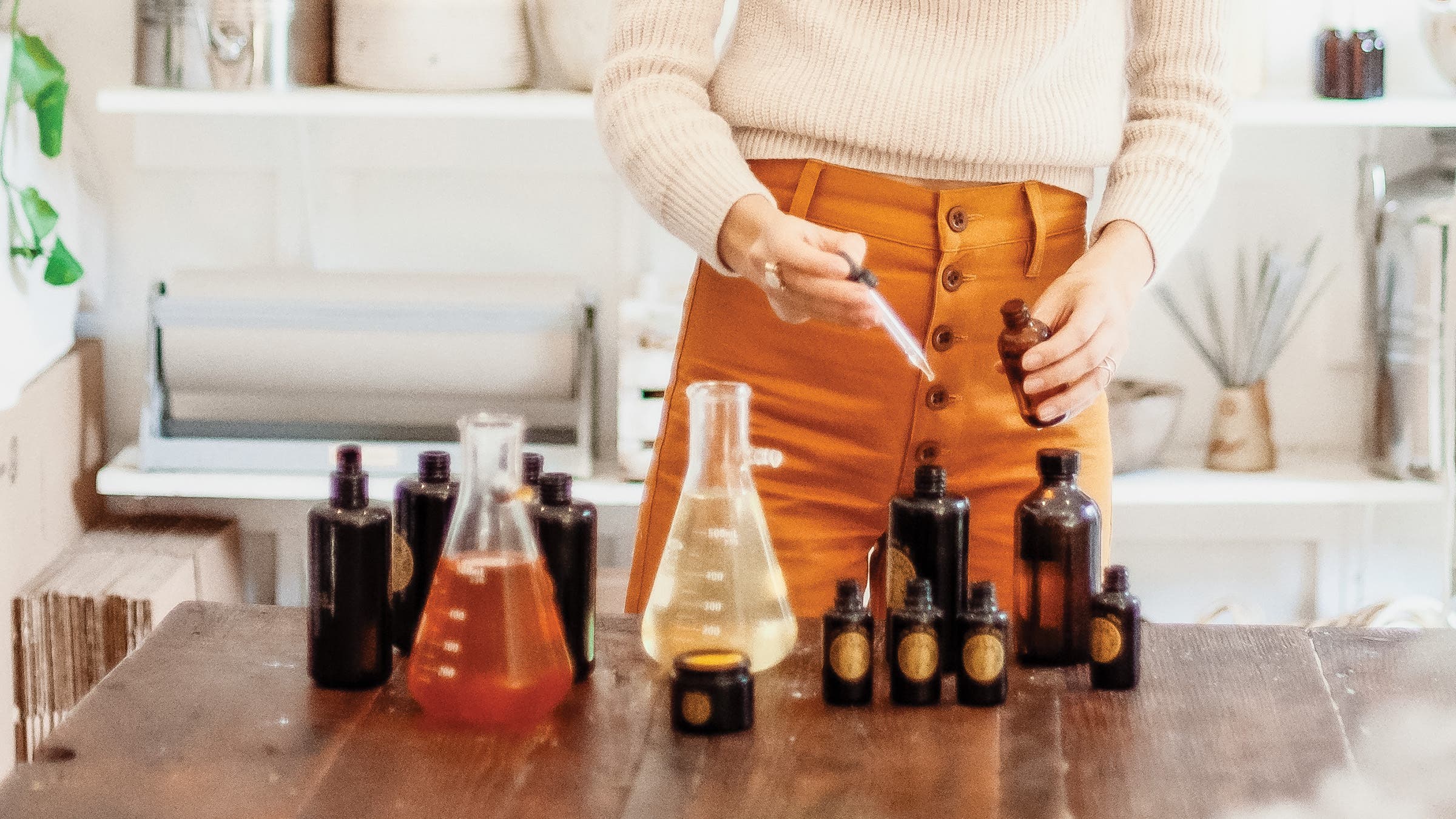 Woman bottling products at Poppy and Someday